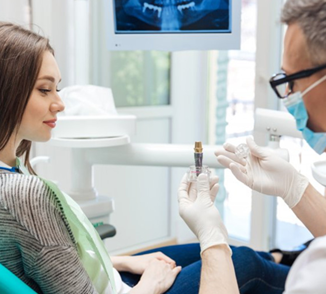 Patient in Mt. Dora talking to dentist about dental implants