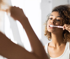 Patient in Mt. Dora brushing their dental implants